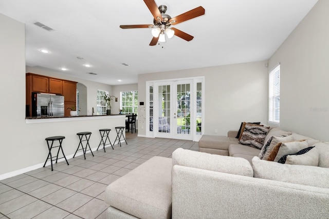13520 Meadow Bay Loop, Orlando, FL 32824 - living room featuring plenty of natural light, ceiling fan, light tile patterned floors, recessed lighting, and arched walkways