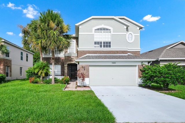 13520 Meadow Bay Loop, Orlando, FL 32824 - view of front of property featuring brick siding, concrete driveway, a garage, and a front lawn