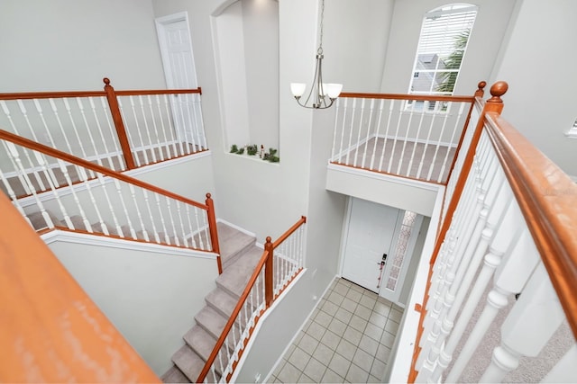 13520 Meadow Bay Loop, Orlando, FL 32824 - stairs with tile patterned flooring and a chandelier