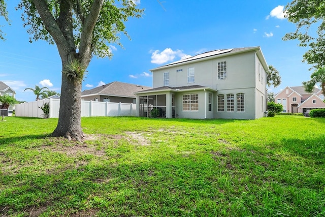 13520 Meadow Bay Loop, Orlando, FL 32824 - back of property with a sunroom, stucco siding, and solar panels