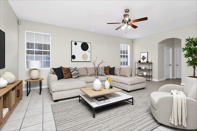 13520 Meadow Bay Loop, Orlando, FL 32824 - living area with arched walkways, a ceiling fan, and light tile patterned floors