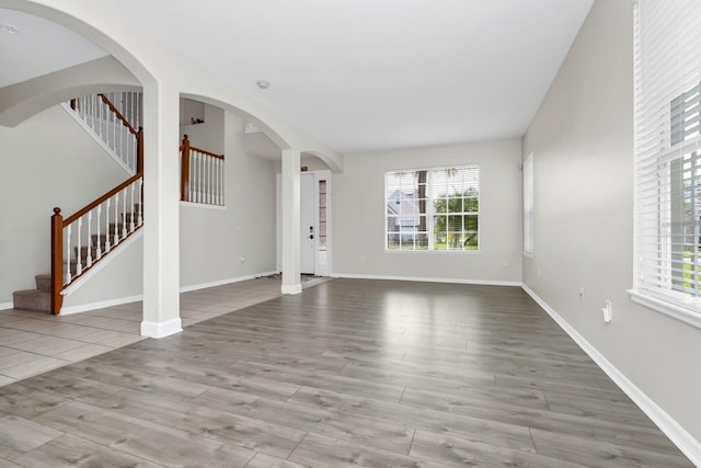 13520 Meadow Bay Loop, Orlando, FL 32824 - unfurnished living room featuring wood finished floors and stairway