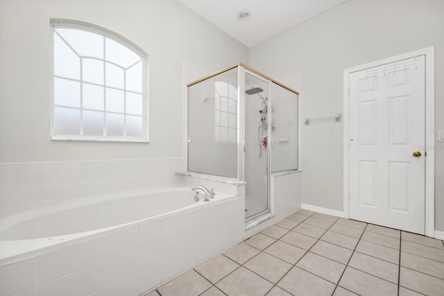 13520 Meadow Bay Loop, Orlando, FL 32824 - bathroom featuring a garden tub, plenty of natural light, a stall shower, and tile patterned flooring