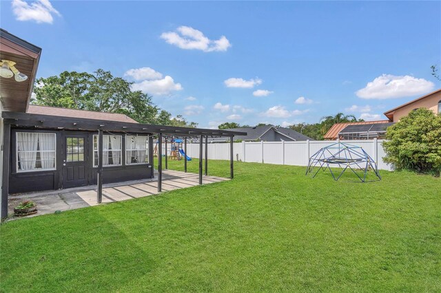 4636 Mesa Verde Dr, Saint Cloud, FL 34769 - fenced backyard with a playground and a patio
