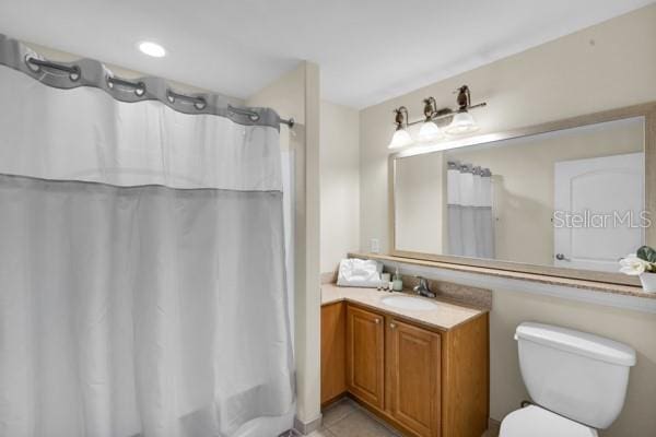 13427 Blue Heron Beach Dr Unit 1205, Orlando, FL 32821 - bathroom featuring toilet, tile patterned floors, shower / tub combo, and vanity