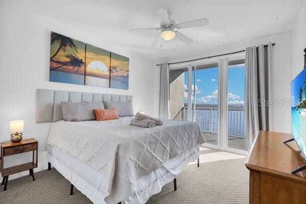 13427 Blue Heron Beach Dr Unit 1205, Orlando, FL 32821 - bedroom with carpet flooring, a ceiling fan, and access to exterior