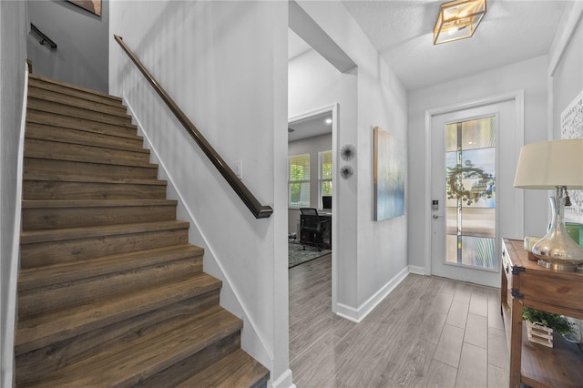 12048 Imaginary Way, Orlando, FL 32832 - entrance foyer featuring stairway, baseboards, and wood finished floors