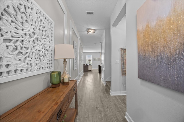 12048 Imaginary Way, Orlando, FL 32832 - corridor featuring wood finished floors, visible vents, and baseboards
