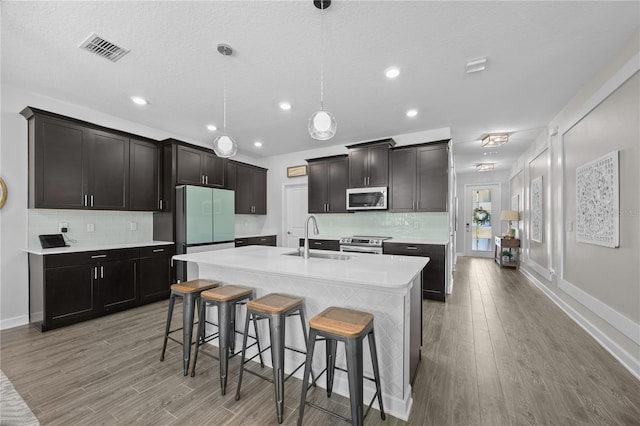 12048 Imaginary Way, Orlando, FL 32832 - kitchen with light wood-style flooring, visible vents, appliances with stainless steel finishes, and a sink