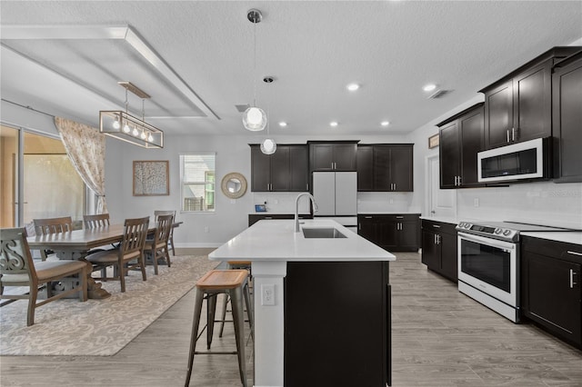 12048 Imaginary Way, Orlando, FL 32832 - kitchen with light countertops, electric stove, a sink, white microwave, and fridge