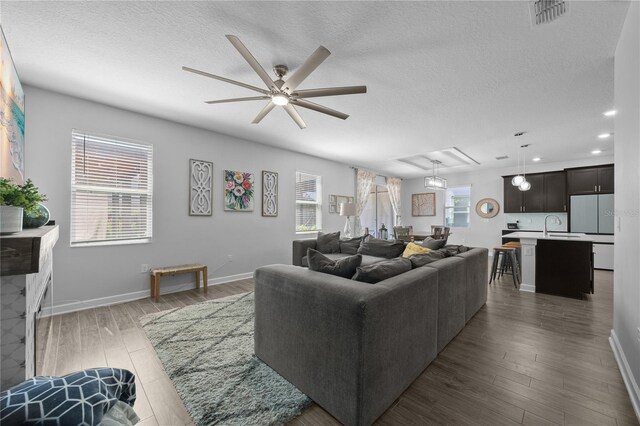 12048 Imaginary Way, Orlando, FL 32832 - living room with recessed lighting, wood finished floors, visible vents, a ceiling fan, and a textured ceiling