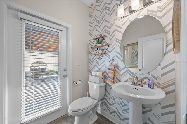 12048 Imaginary Way, Orlando, FL 32832 - bathroom with wallpapered walls, wood finished floors, baseboards, and toilet