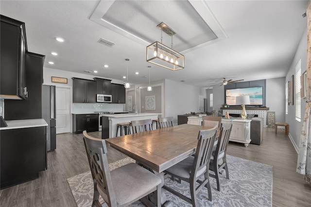 12048 Imaginary Way, Orlando, FL 32832 - dining area featuring visible vents, baseboards, recessed lighting, wood finished floors, and ceiling fan