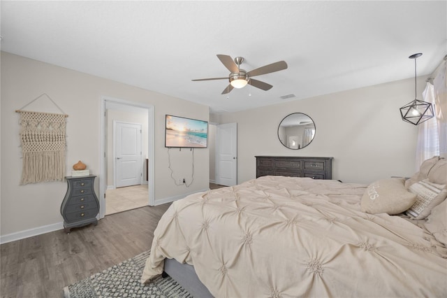 12048 Imaginary Way, Orlando, FL 32832 - bedroom featuring wood finished floors, visible vents, baseboards, and ceiling fan