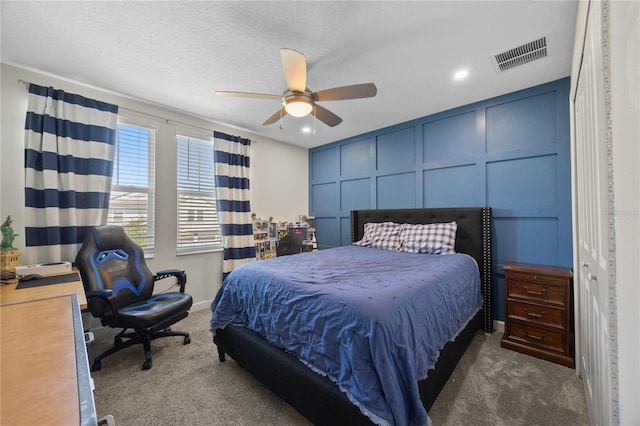 12048 Imaginary Way, Orlando, FL 32832 - bedroom with visible vents, recessed lighting, ceiling fan, a decorative wall, and carpet floors