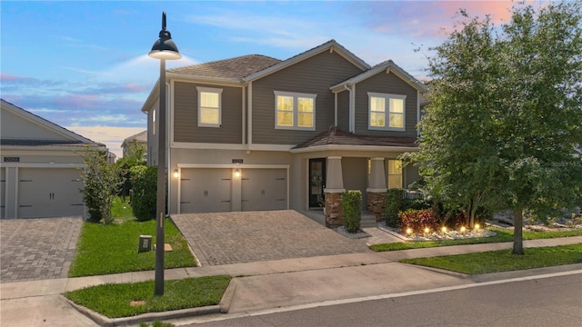 12048 Imaginary Way, Orlando, FL 32832 - view of front of property with stucco siding, driveway, a yard, and a garage