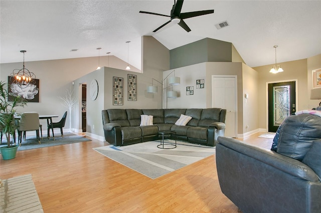 400 Shelby Ct, Apopka, FL 32712 - living room featuring a chandelier, vaulted ceiling, baseboards, a ceiling fan, and light wood-style floors