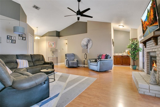 400 Shelby Ct, Apopka, FL 32712 - living area with ceiling fan, a brick fireplace, light wood-style flooring, vaulted ceiling, and baseboards