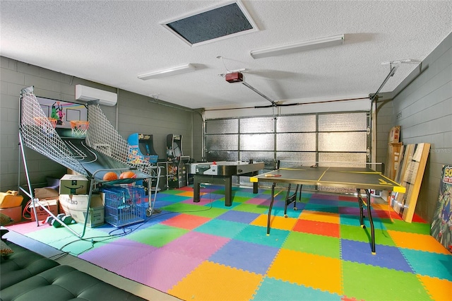 400 Shelby Ct, Apopka, FL 32712 - recreation room with tile patterned floors, a textured ceiling, a garage, a wall mounted air conditioner, and concrete block wall