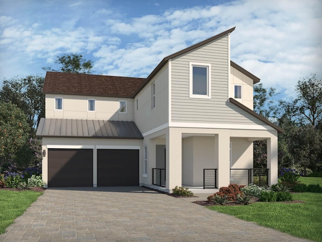 view of front of home featuring decorative driveway, an attached garage, a standing seam roof, metal roof, and covered porch