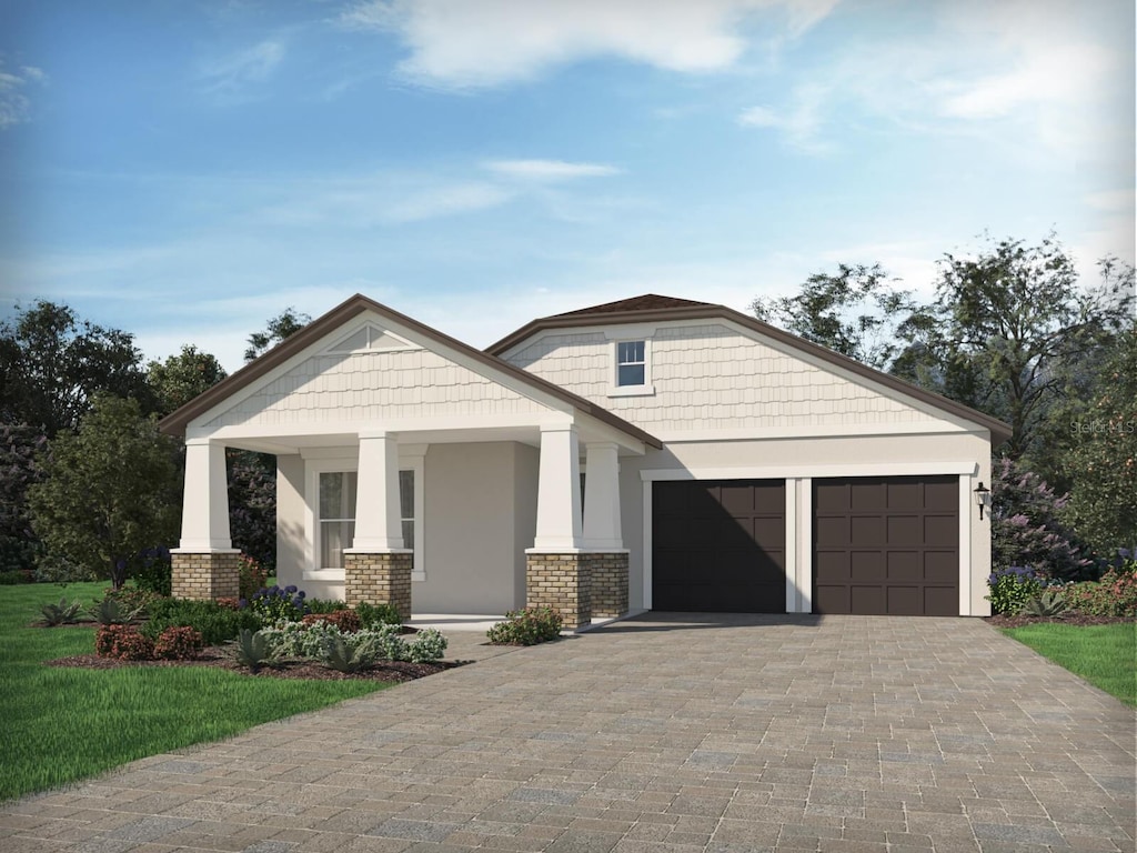 view of front of home featuring driveway, stucco siding, and an attached garage