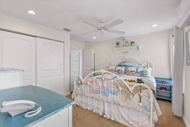 bedroom featuring recessed lighting, ceiling fan, visible vents, light carpet, and a closet
