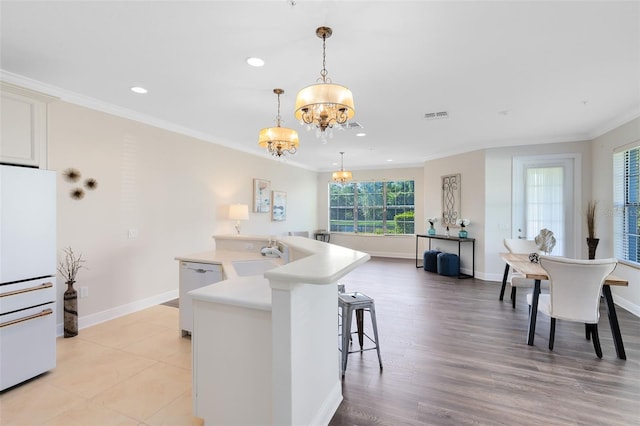 1565 Corkery Ct, Winter Springs, FL 32708 - kitchen with an inviting chandelier, white appliances, a sink, and ornamental molding
