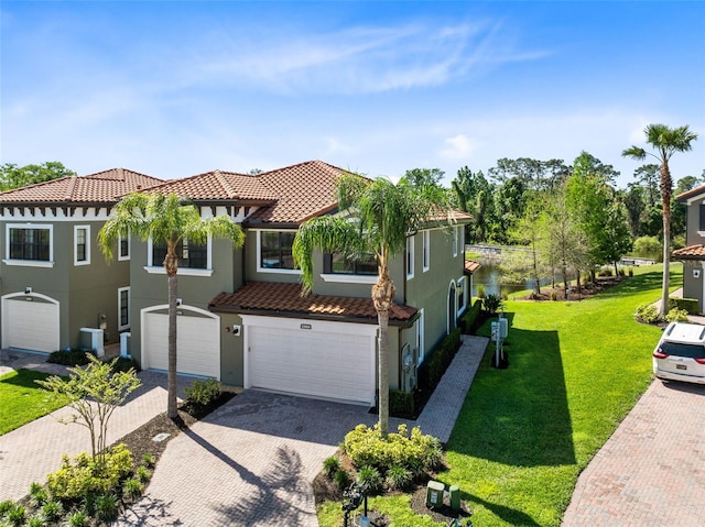 1565 Corkery Ct, Winter Springs, FL 32708 - mediterranean / spanish home featuring stucco siding, decorative driveway, a front lawn, a tile roof, and an attached garage