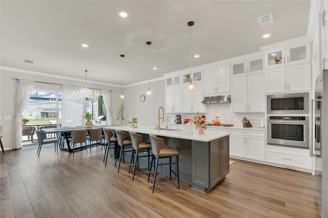 13640 Haulover Beach Ln, Orlando, FL 32827 - kitchen with a sink, visible vents, built in appliances, and under cabinet range hood