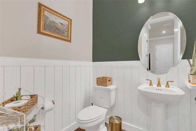 13640 Haulover Beach Ln, Orlando, FL 32827 - half bathroom featuring toilet and a wainscoted wall