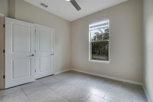 unfurnished bedroom with baseboards, ceiling fan, and visible vents