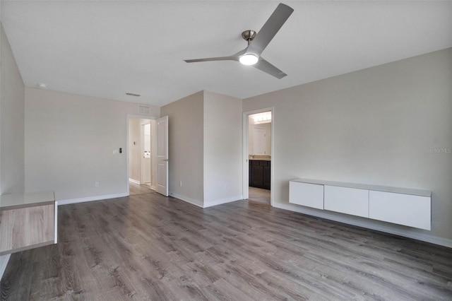 unfurnished living room with baseboards, visible vents, ceiling fan, and wood finished floors