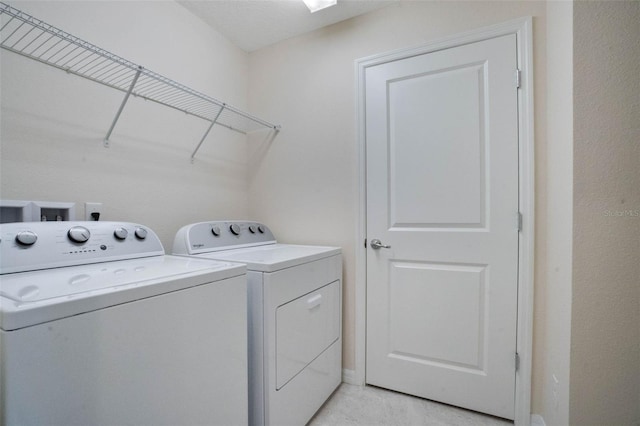 washroom featuring laundry area and washer and clothes dryer