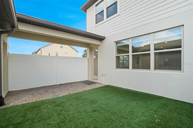 view of yard with fence and a patio