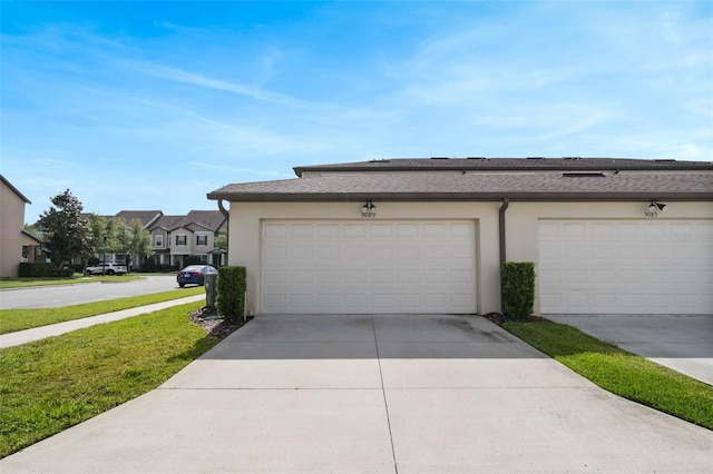 garage with driveway and a residential view