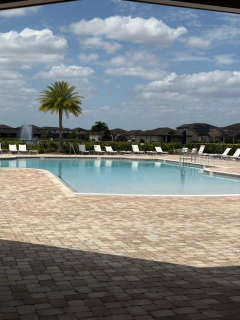 community pool featuring a patio area