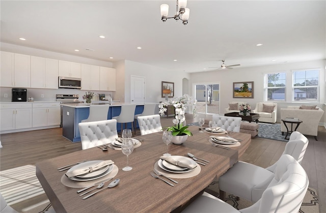 5 Reine Pl, Palm Coast, FL 32164 - dining space with light wood finished floors, recessed lighting, and ceiling fan with notable chandelier