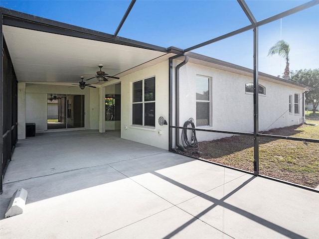 unfurnished sunroom with a ceiling fan