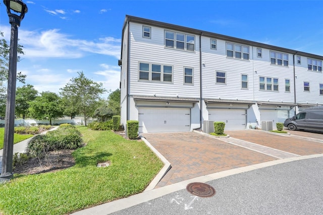 7772 Sweet Star Ave, Orlando, FL 32836 - multi unit property with an attached garage, a front lawn, driveway, and central air condition unit