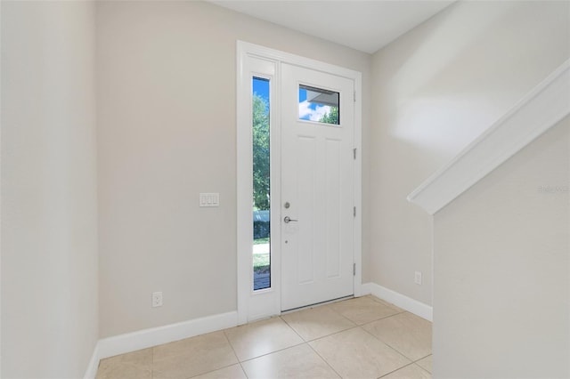 7772 Sweet Star Ave, Orlando, FL 32836 - foyer entrance with light tile patterned flooring, baseboards, and plenty of natural light