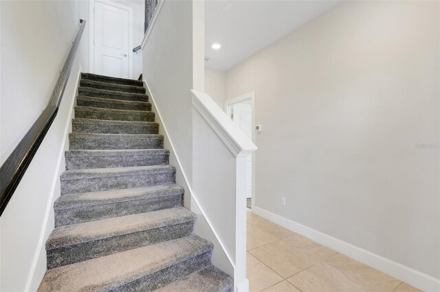 7772 Sweet Star Ave, Orlando, FL 32836 - stairs with recessed lighting, tile patterned floors, and baseboards