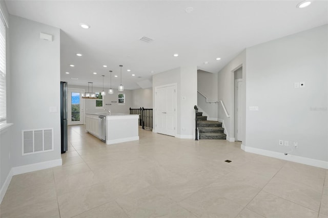 7772 Sweet Star Ave, Orlando, FL 32836 - unfurnished living room featuring baseboards, recessed lighting, stairway, visible vents, and a sink