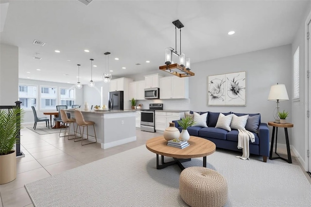 7772 Sweet Star Ave, Orlando, FL 32836 - living room with visible vents, baseboards, light tile patterned floors, an inviting chandelier, and recessed lighting