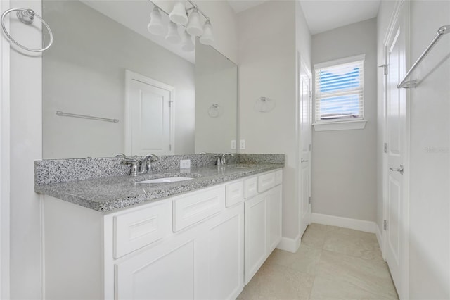 7772 Sweet Star Ave, Orlando, FL 32836 - full bath featuring double vanity, a sink, tile patterned flooring, and baseboards