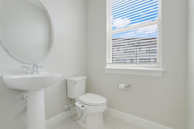 7772 Sweet Star Ave, Orlando, FL 32836 - half bathroom featuring toilet, baseboards, and tile patterned flooring