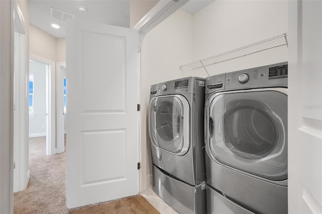 7772 Sweet Star Ave, Orlando, FL 32836 - laundry room featuring visible vents, washing machine and dryer, light colored carpet, and laundry area