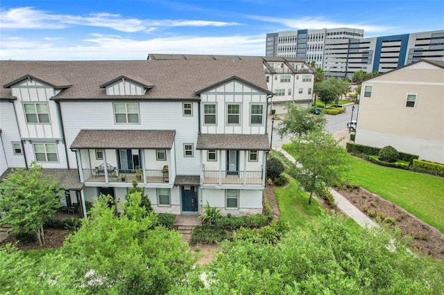 7772 Sweet Star Ave, Orlando, FL 32836 - back of property with a lawn, a balcony, and a shingled roof