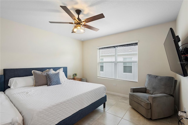 bedroom featuring light tile patterned floors, baseboards, and a ceiling fan
