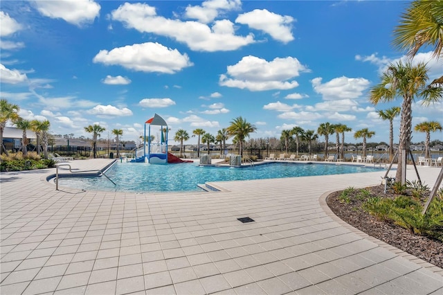 pool with a patio and a water slide