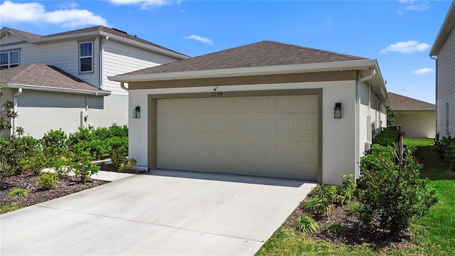 garage with concrete driveway